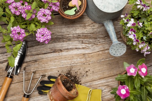 Trained gardener following safe working procedures