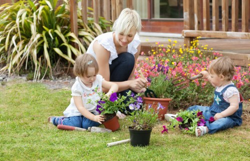 Gardener loading green waste in a Hendon front garden